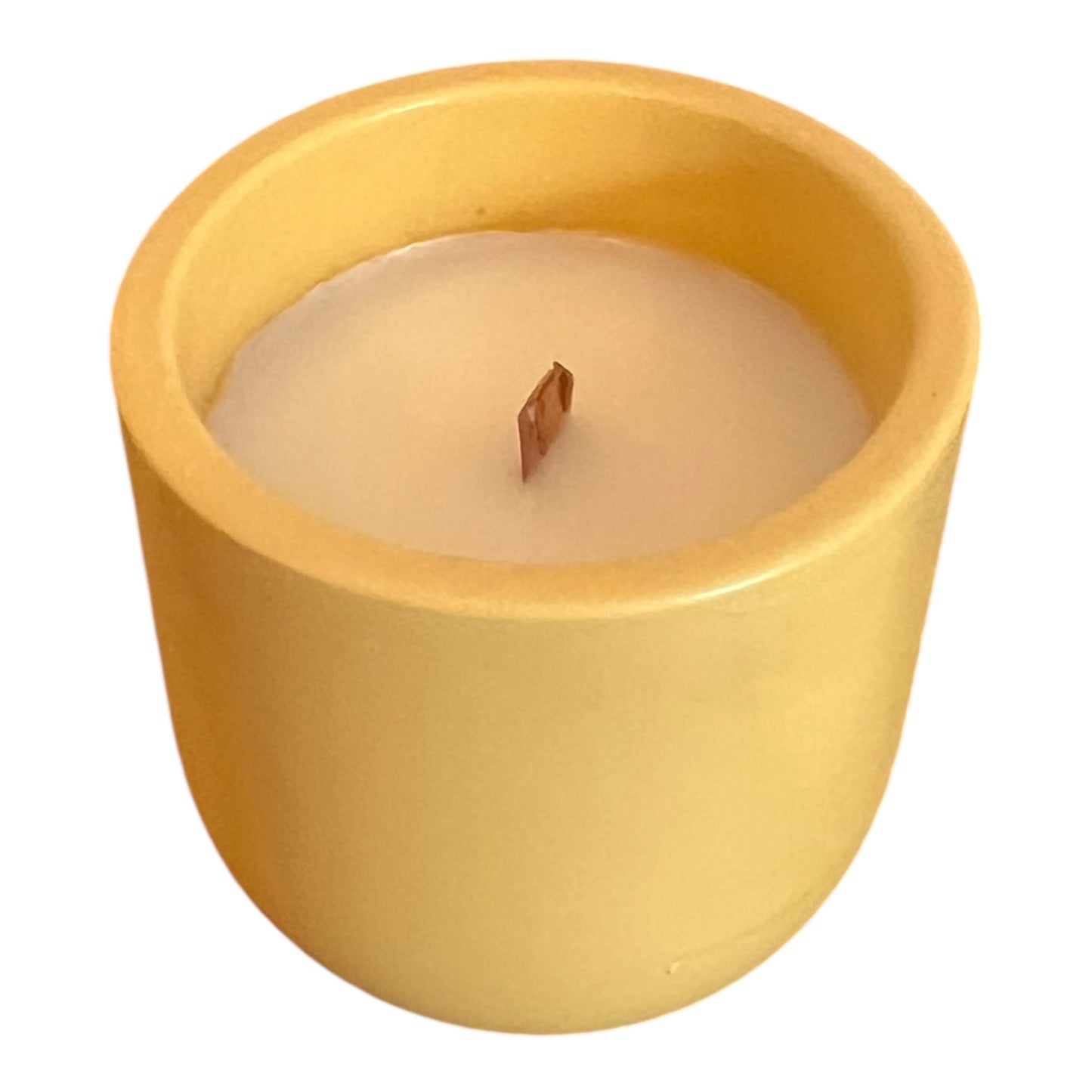 Yellow candle in a pot with a white background