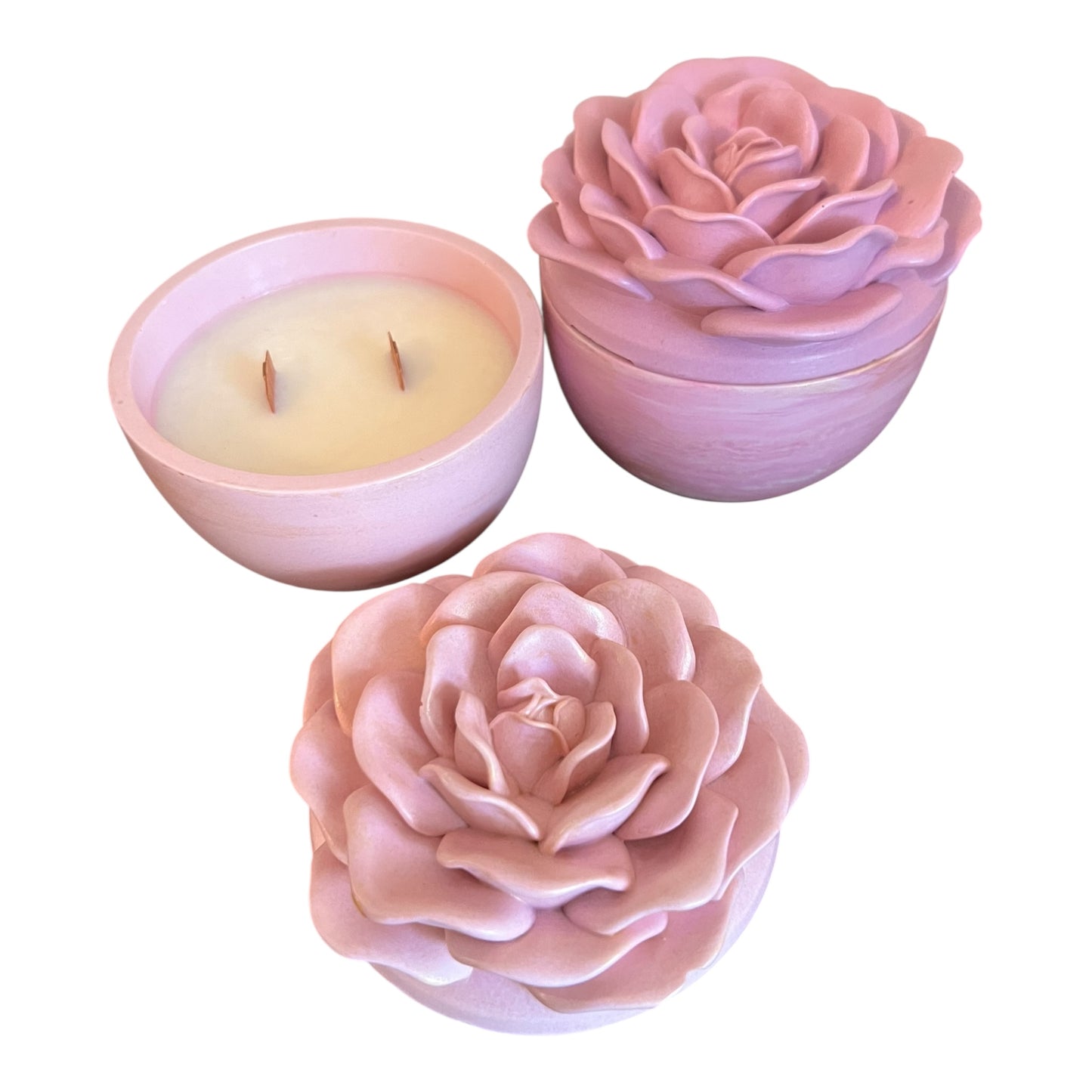 Two rose-shaped candles on a white background