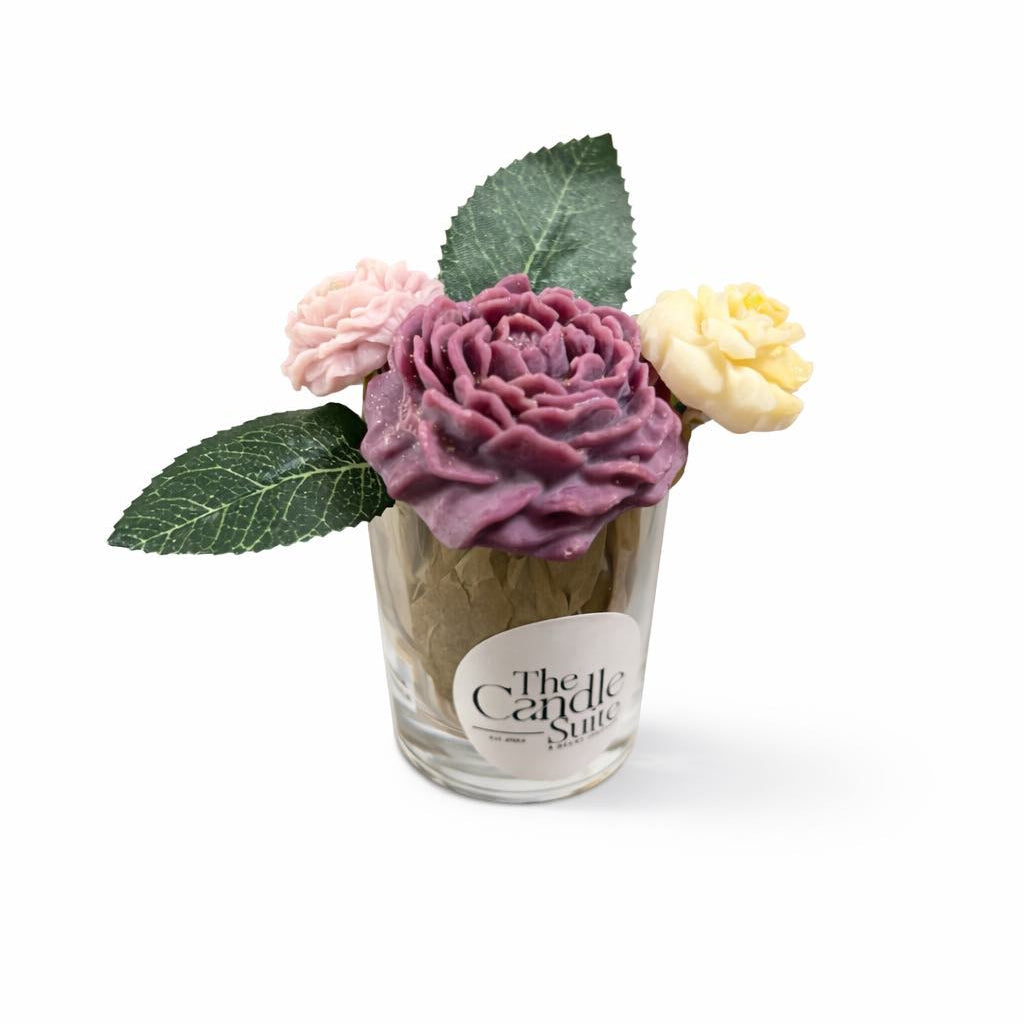 Small glass jar with decorative flowers on a white background