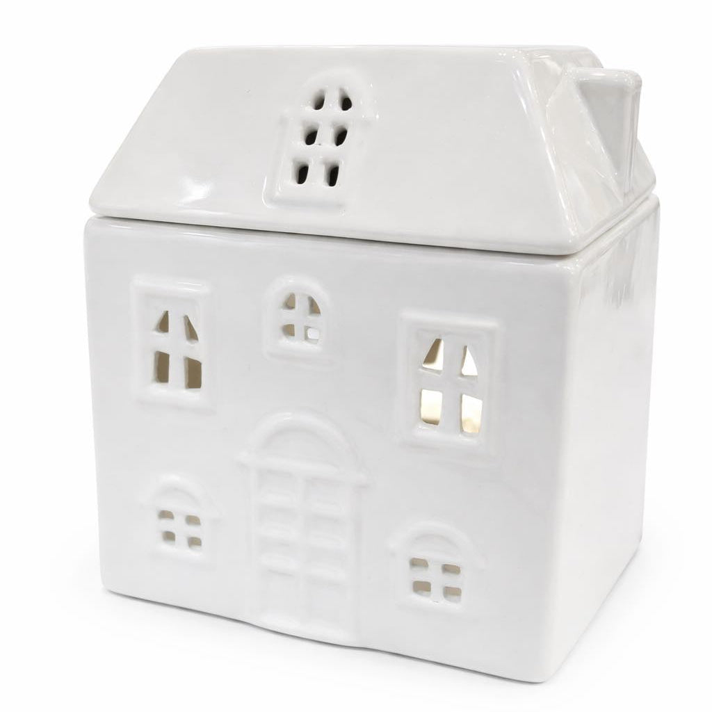 White ceramic house-shaped lantern with small windows on a white background