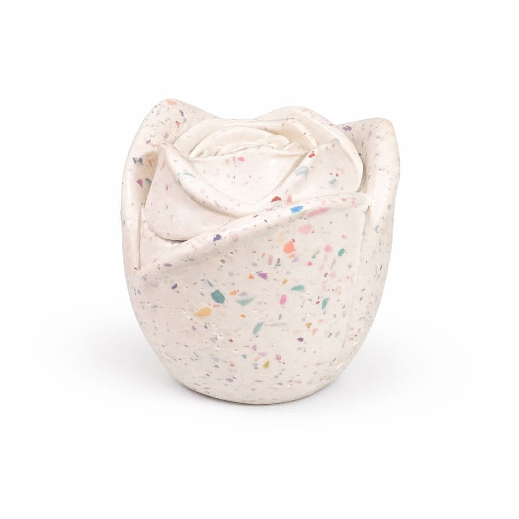 Speckled ceramic rose-shaped candle container on a white background
