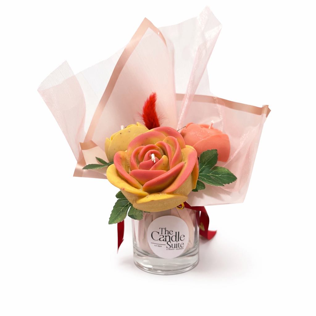 Bouquet of flower-shaped candles in a glass container with 'The Candle Suite' label on a white background