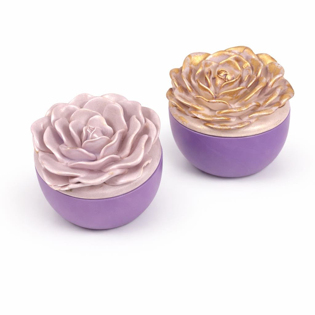 Two decorative items shaped like flowers with purple bases on a white background