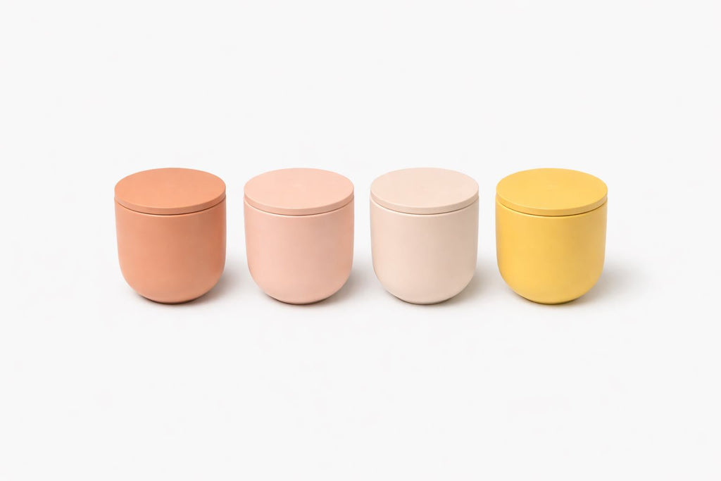 Four colorful jars with lids on a white background