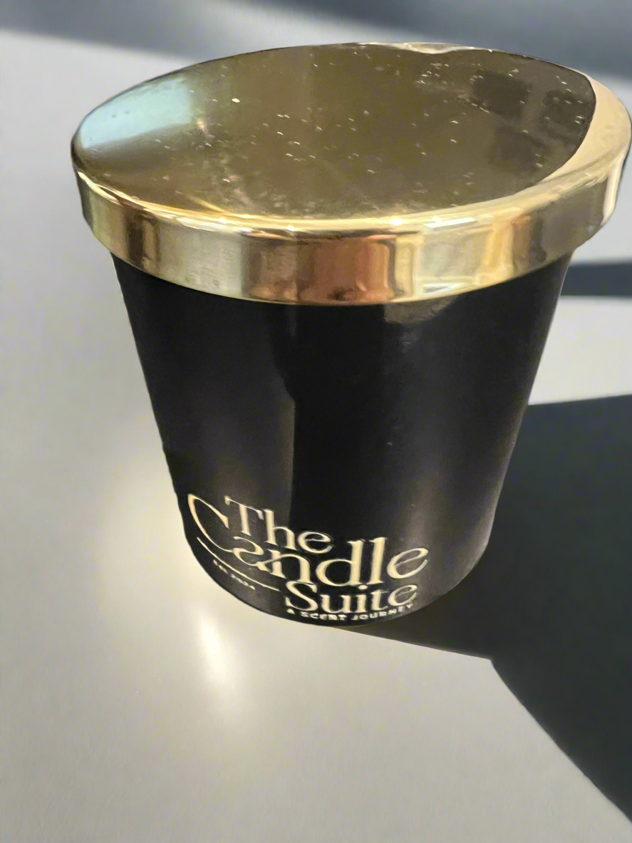 Luxury glass jar candle in black with golden lid.