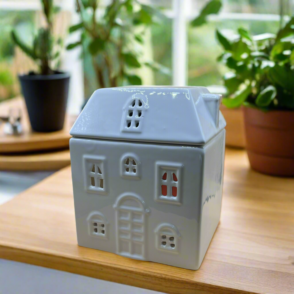 Rustic ceramic cottage-shaped wax melt burner, adding both fragrance and charm to your home decor