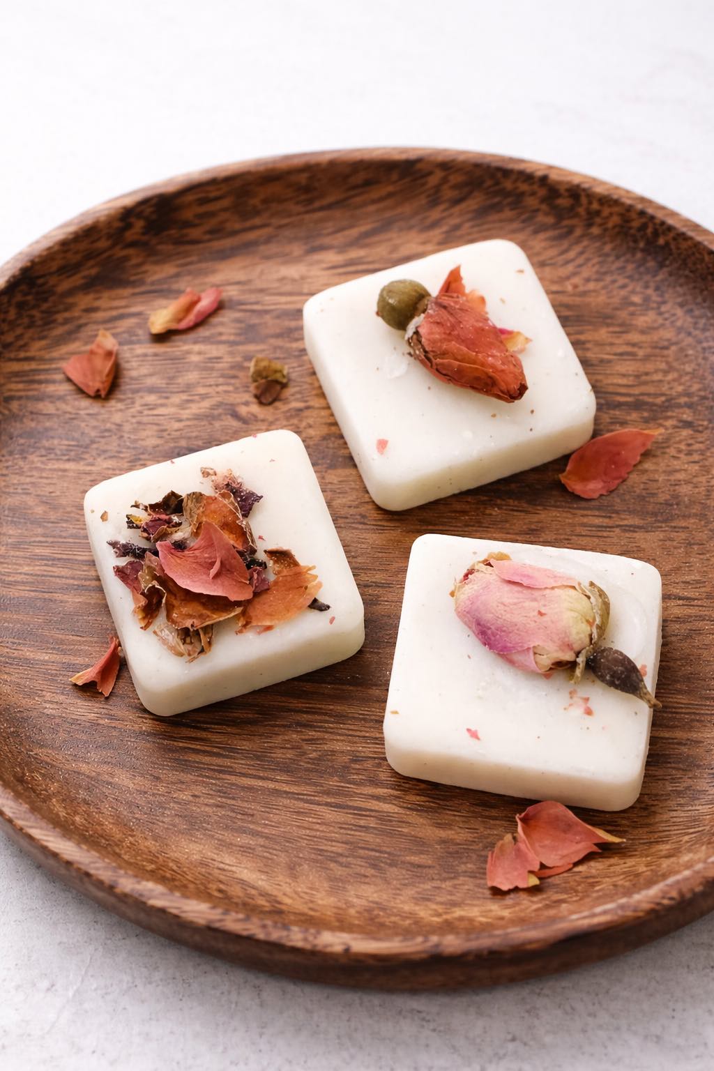 Three wax melt square  with dried flowers on a wooden plate