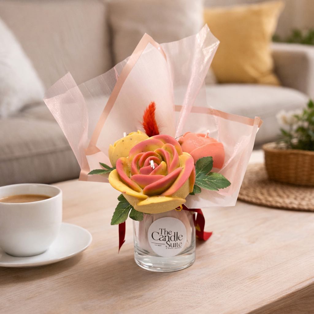 Floral arrangement in a glass vase with a coffee cup on a table in a cozy living room.