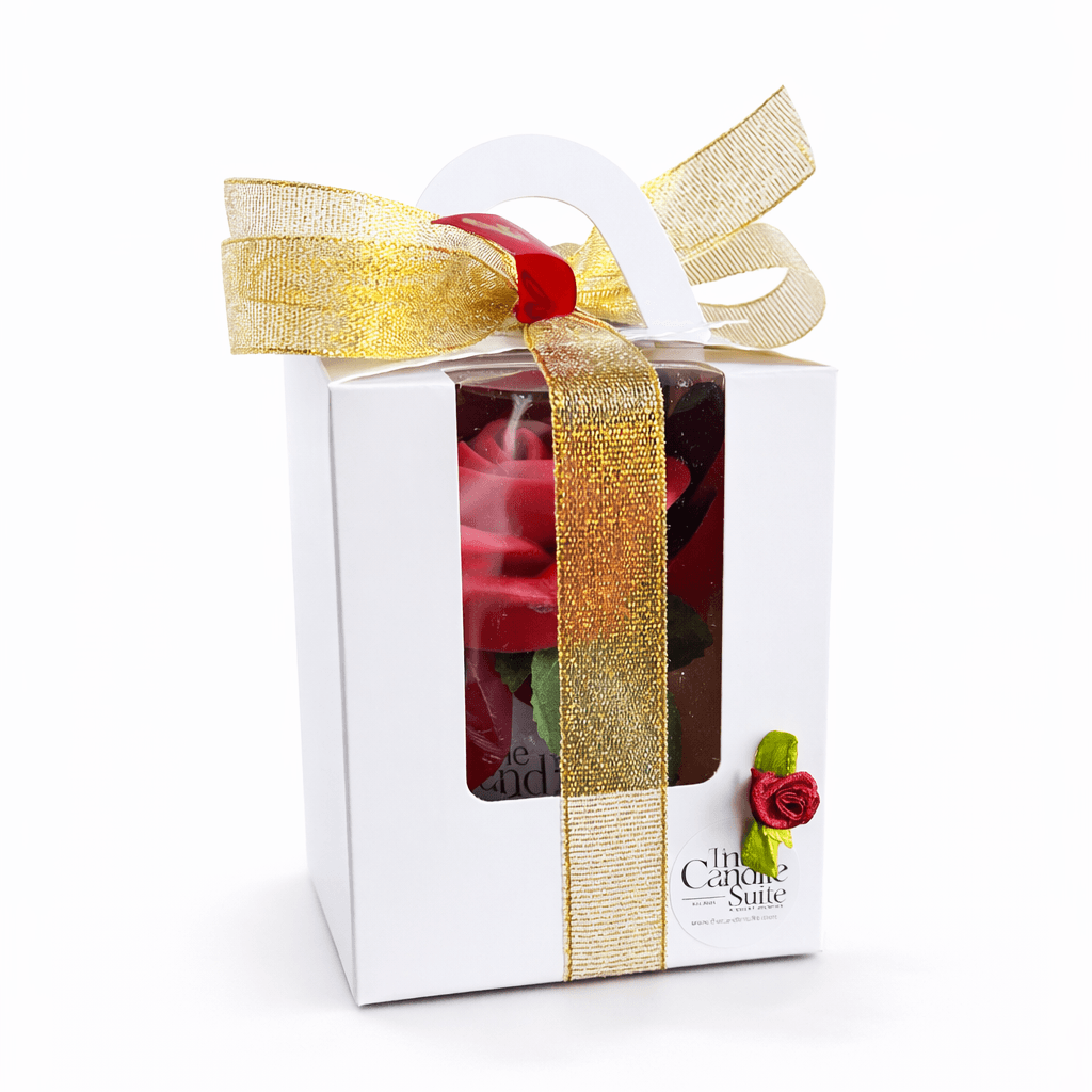 Gift box with a rose and gold ribbon on a white background