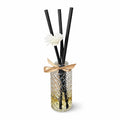 Diffuser with black sticks and a white flower on a white background