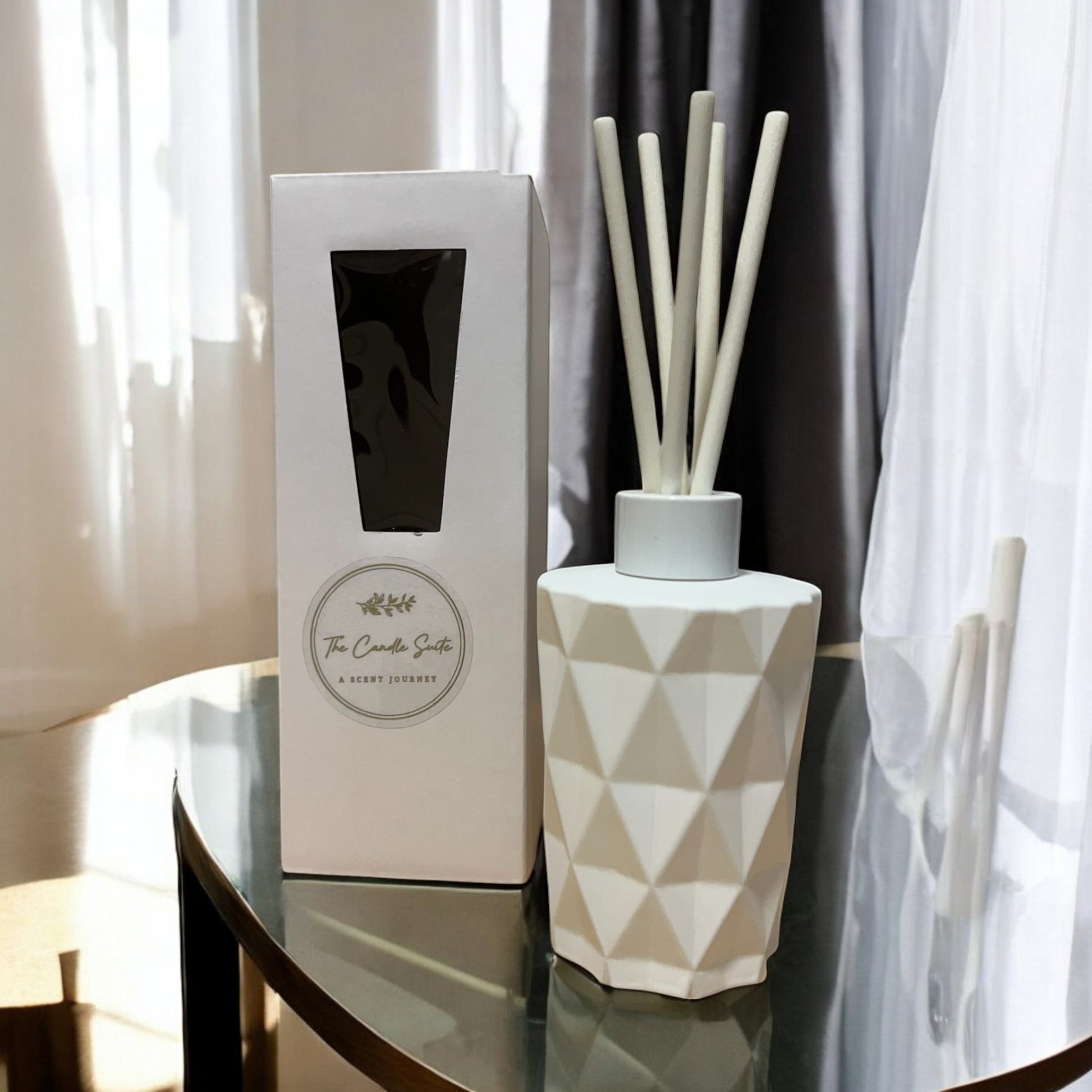 Sophisticated reed diffusers in sleek white bottles, hand-poured for premium scent diffusion