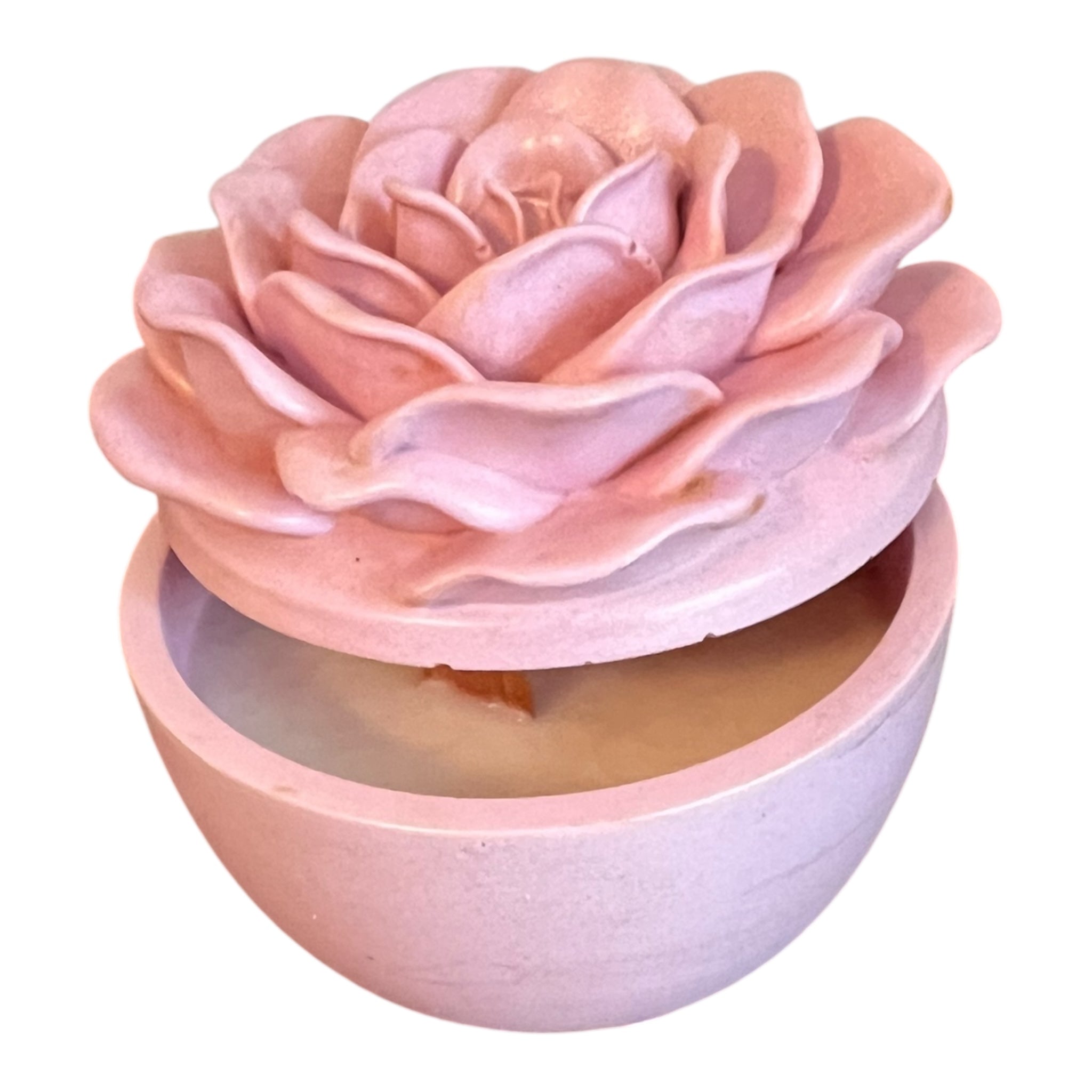 Pink rose-shaped soap bar in a container on a white background