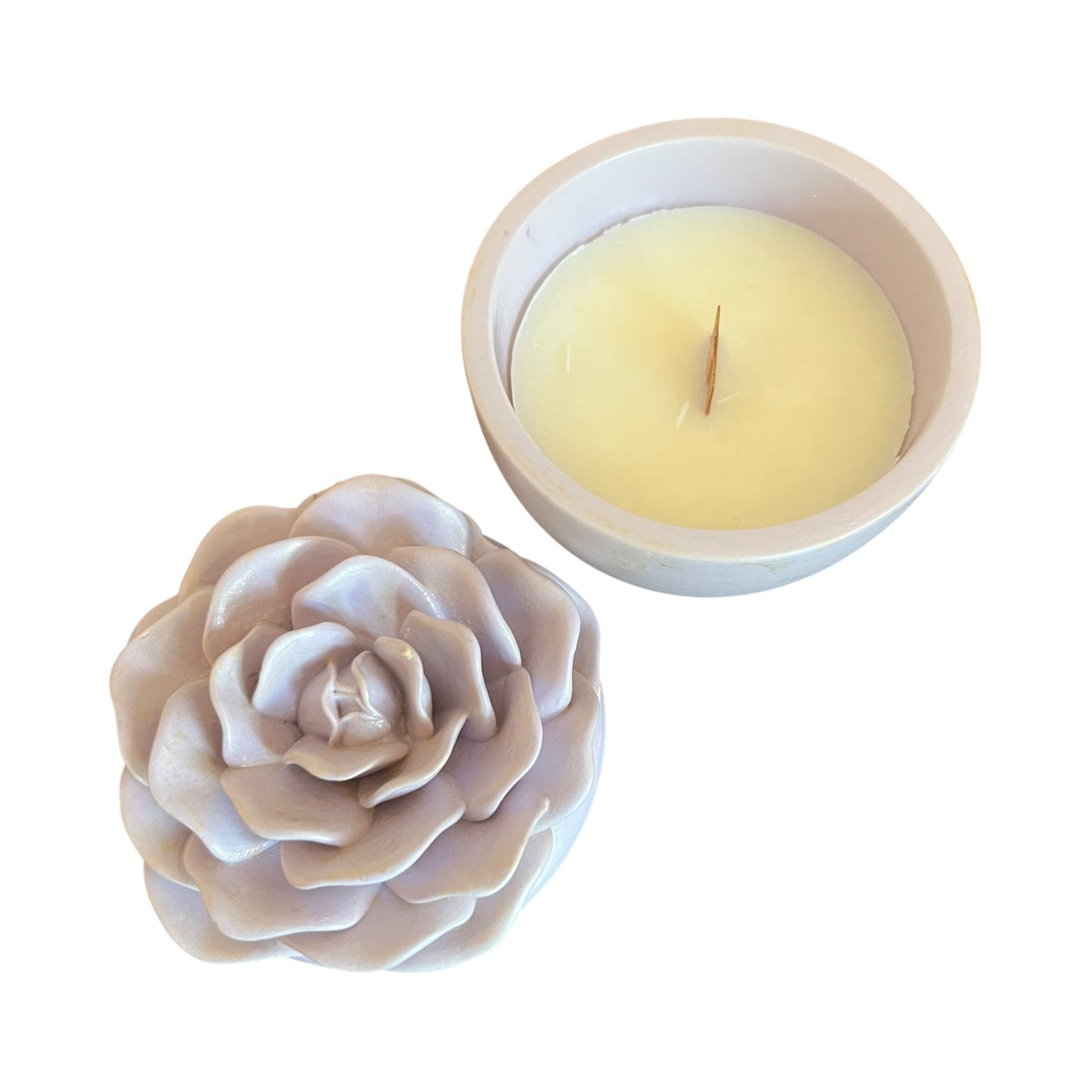 Floral-shaped candle holder with a candle inside on a white background