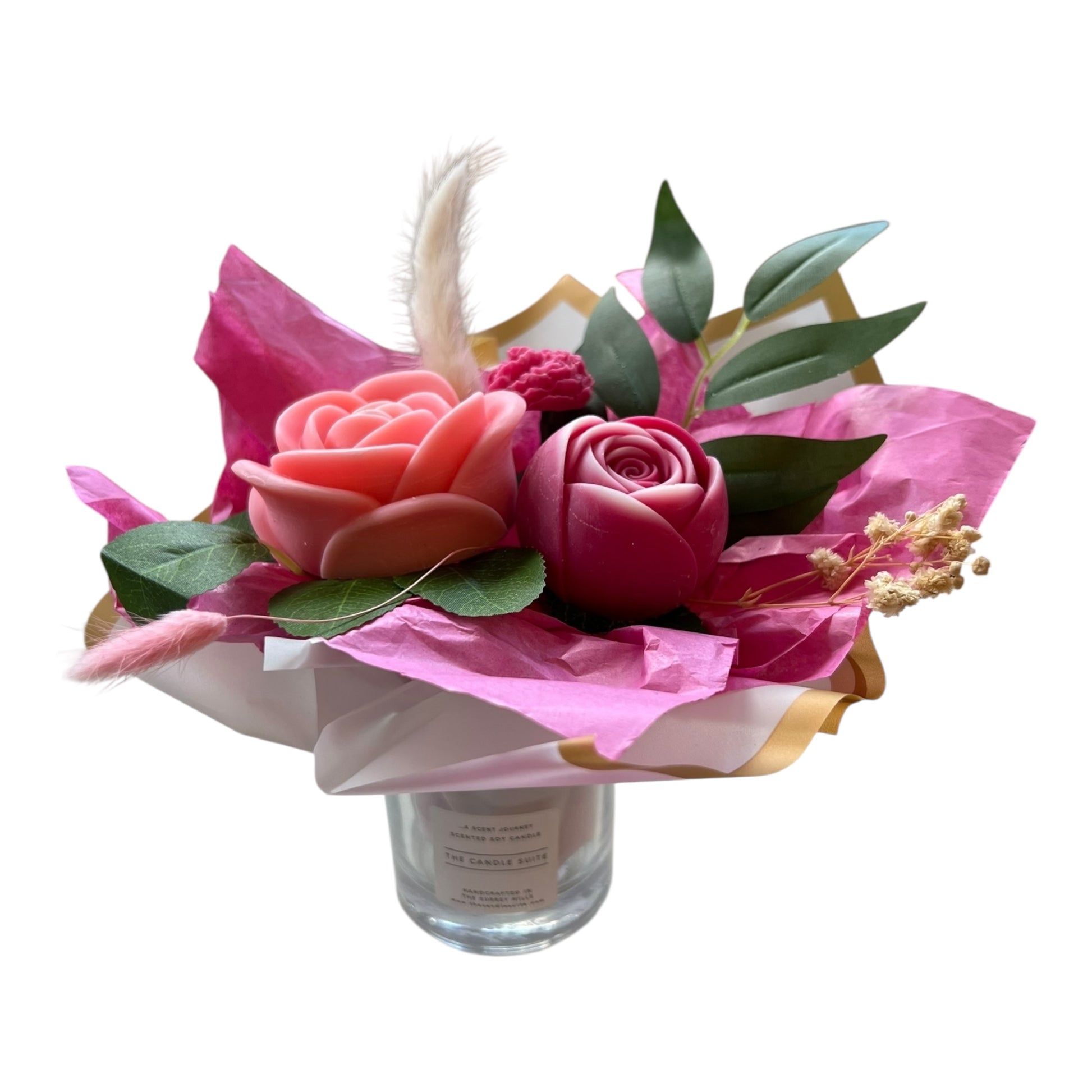 Bouquet of pink and red roses with green leaves in a clear vase on a white background