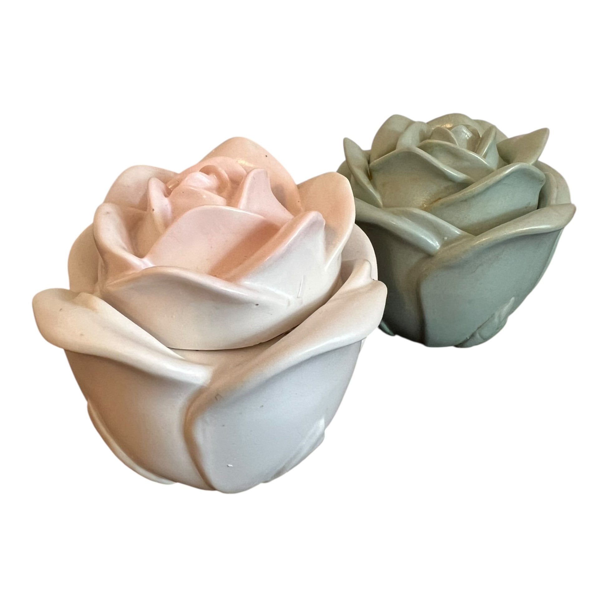 Two ceramic rose-shaped planters in pastel colors on a white background