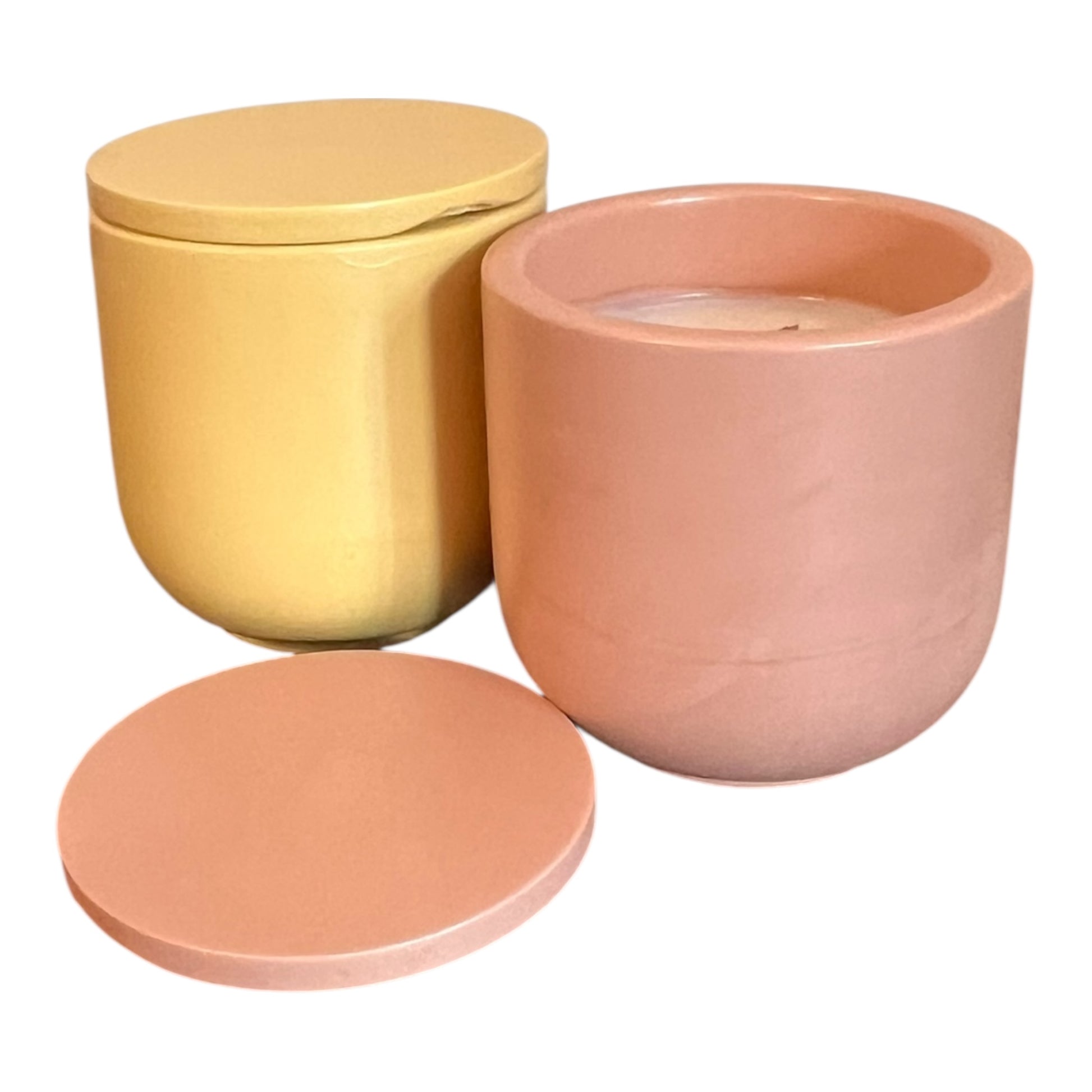 Two ceramic pots, one yellow and one peach-colored, with lids on a white background.
