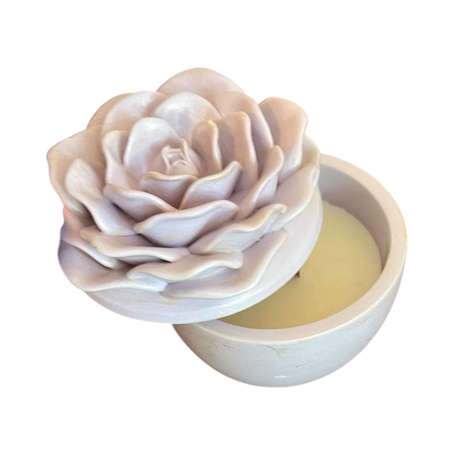 Rose-shaped soap bar in a white container on a white background