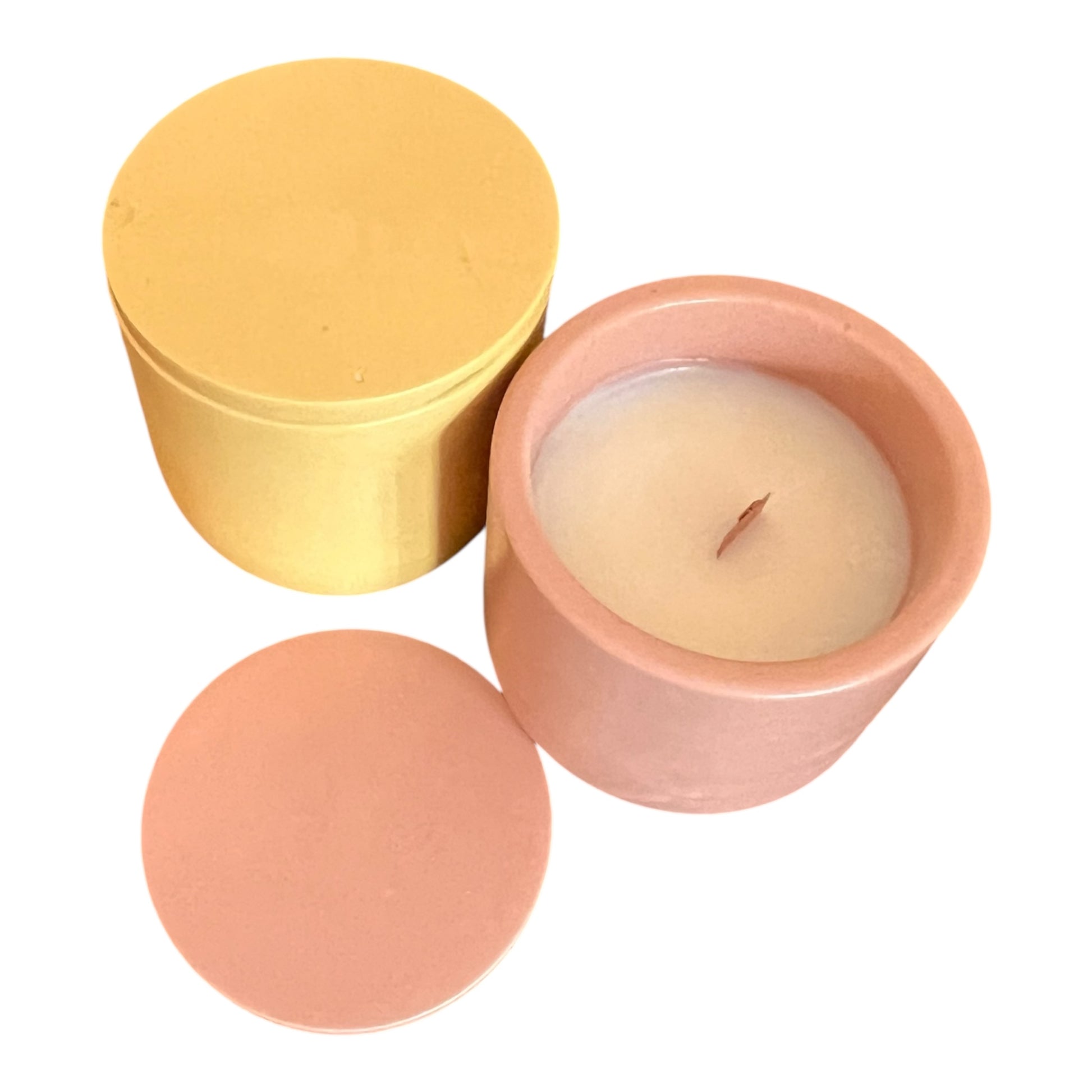 Candle in a terracotta pot with a yellow lid on a white background