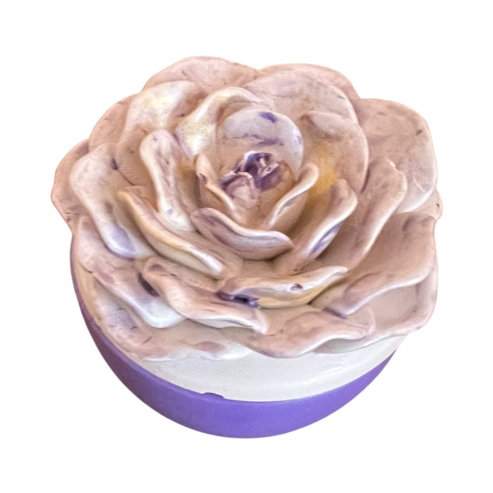 Rose-shaped bath bomb with a purple base on a white background