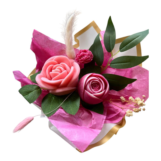 Floral arrangement with pink roses and green leaves on a white background
