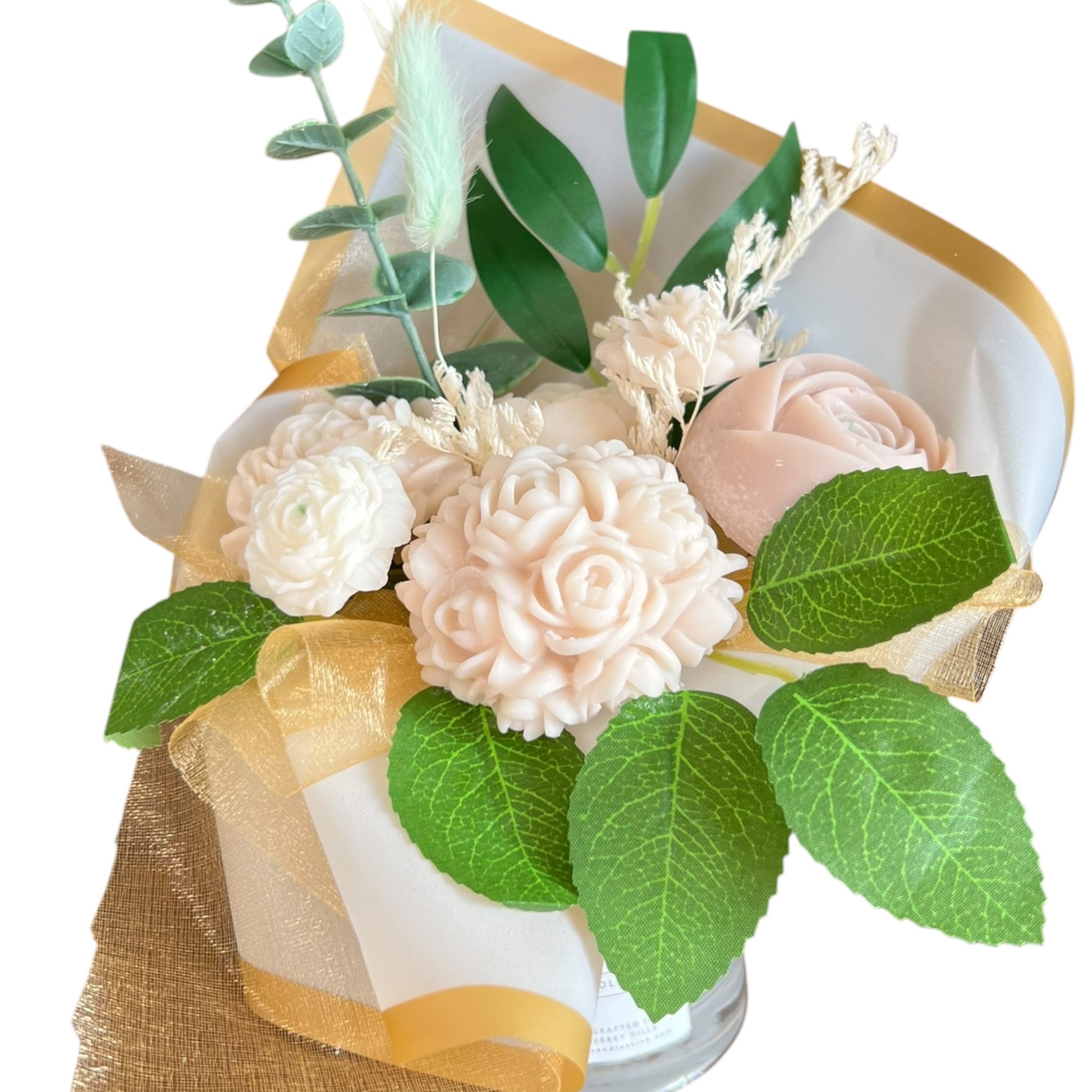 Bouquet of flowers wrapped in gold paper with green leaves on a white background