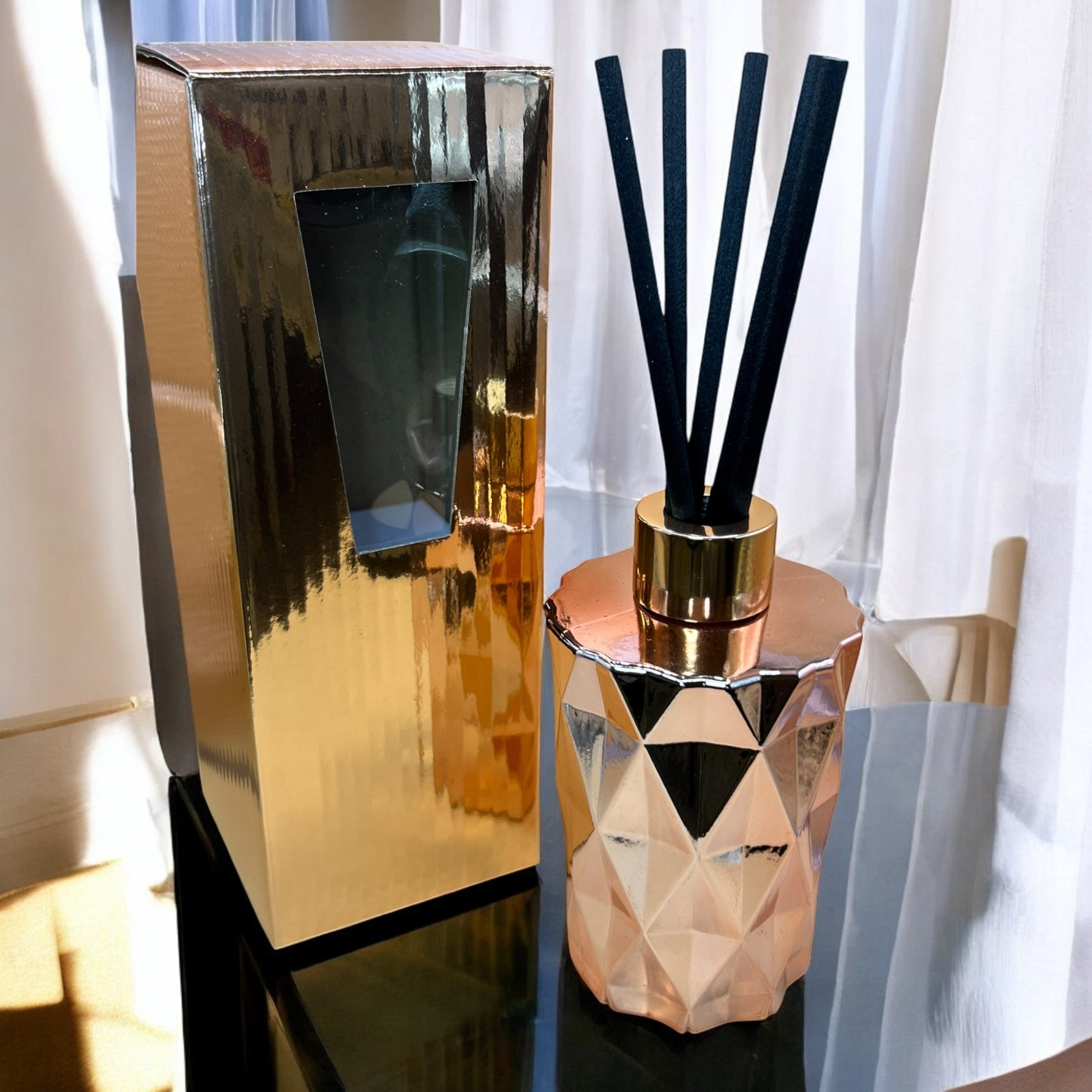 Exquisite hand-poured reed diffuser in a rose gold bottle, creating a soothing atmosphere with timeless design.